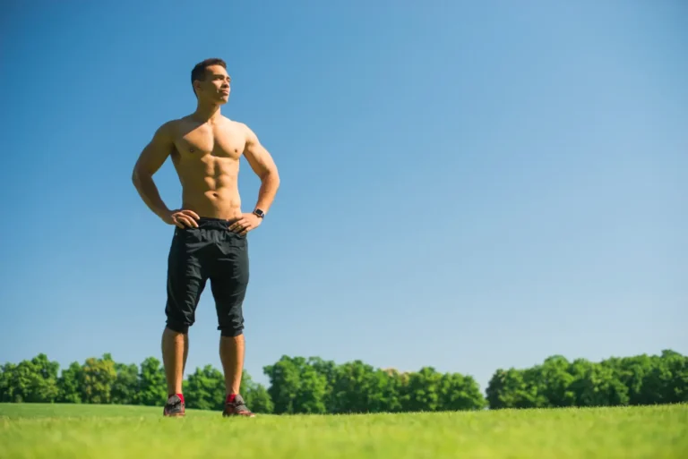 a man standing in a grassy area-Men's Health Coaching & Fitness Training