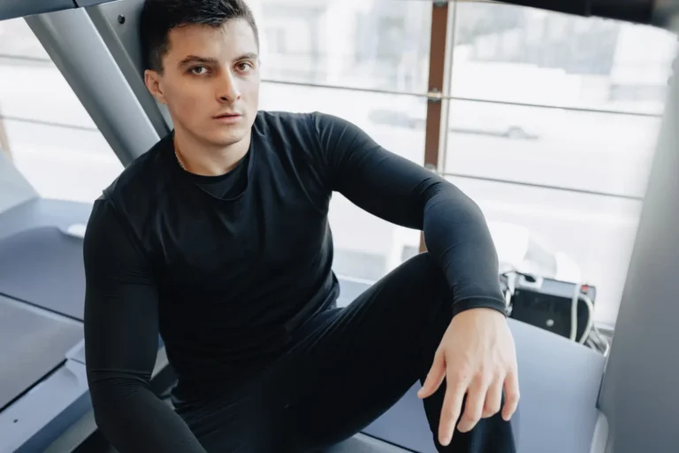 a man sitting in a gym-Men's Health Coaching & Fitness Training